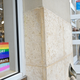 A woman wears a face masks to help curb the spread of COVID-19 outside a Columbia store, as a sign in a window shows support for LGBTQ+ Pride Month, at the Orlando Vineland Premium Outlets shopping mall during a new coronavirus pandemic, Sunday, June 20, 2021, in Orlando, Fla.